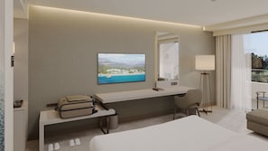 A modern hotel room with a large bed, a desk with a laptop, a television displaying a scenic view, a standing lamp, and a window with a view of the outdoors.