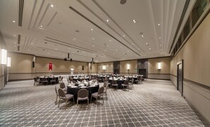 A large conference room with multiple round tables, each set with chairs and dining ware. -  Mirage Park Resort - Premium All Inclusive (Kemer)
