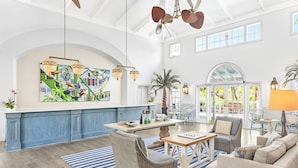 A spacious living area with a large window, a dining table, and comfortable seating. - Hyatt Vacation Club at Beach House, Key West (Key West)