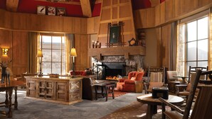 A cozy, rustic interior with a fireplace, wooden furniture, and a chandelier. - The Residences at Mountain Lodge, Beaver Creek by Hyatt Vacation Club (Avon)