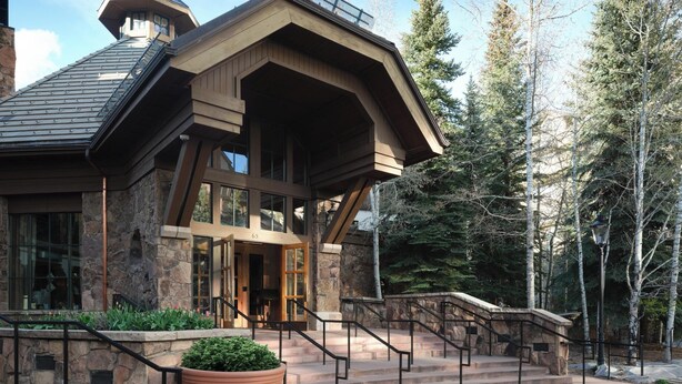 A lodge with a stone facade, large windows, and a prominent entrance with steps. - The Residences at Mountain Lodge, Beaver Creek by Hyatt Vacation Club (Avon)