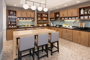 Una cocina moderna con armarios de madera, una isla central e iluminación colgante.