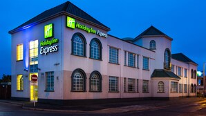 A Holiday Inn Express building with a classic architectural style, featuring arched windows and a symmetrical facade. - Holiday Inn Express London Chingford by IHG (London)