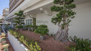 A building with a sign reading "MirSpa" and a landscaped area with trees and shrubs. - Rhodos Horizon Blu (Rhodes)