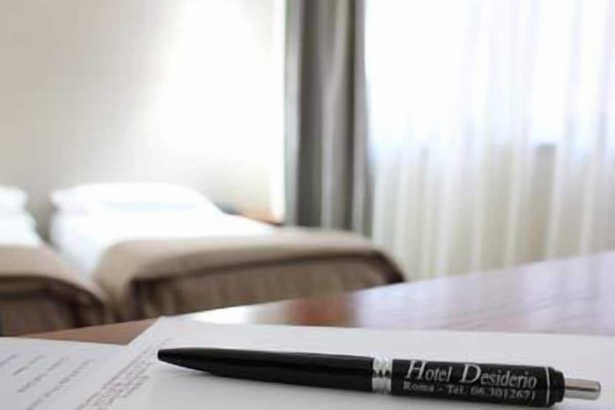 A hotel pen on a document, with a blurred background of a room.