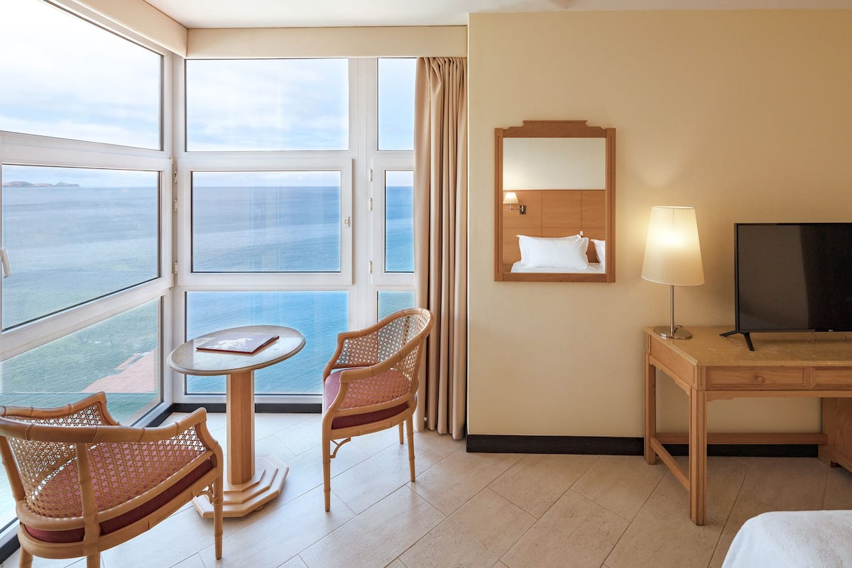 junior suite, sea view | in-room safe, desk, blackout curtains, free wifi
