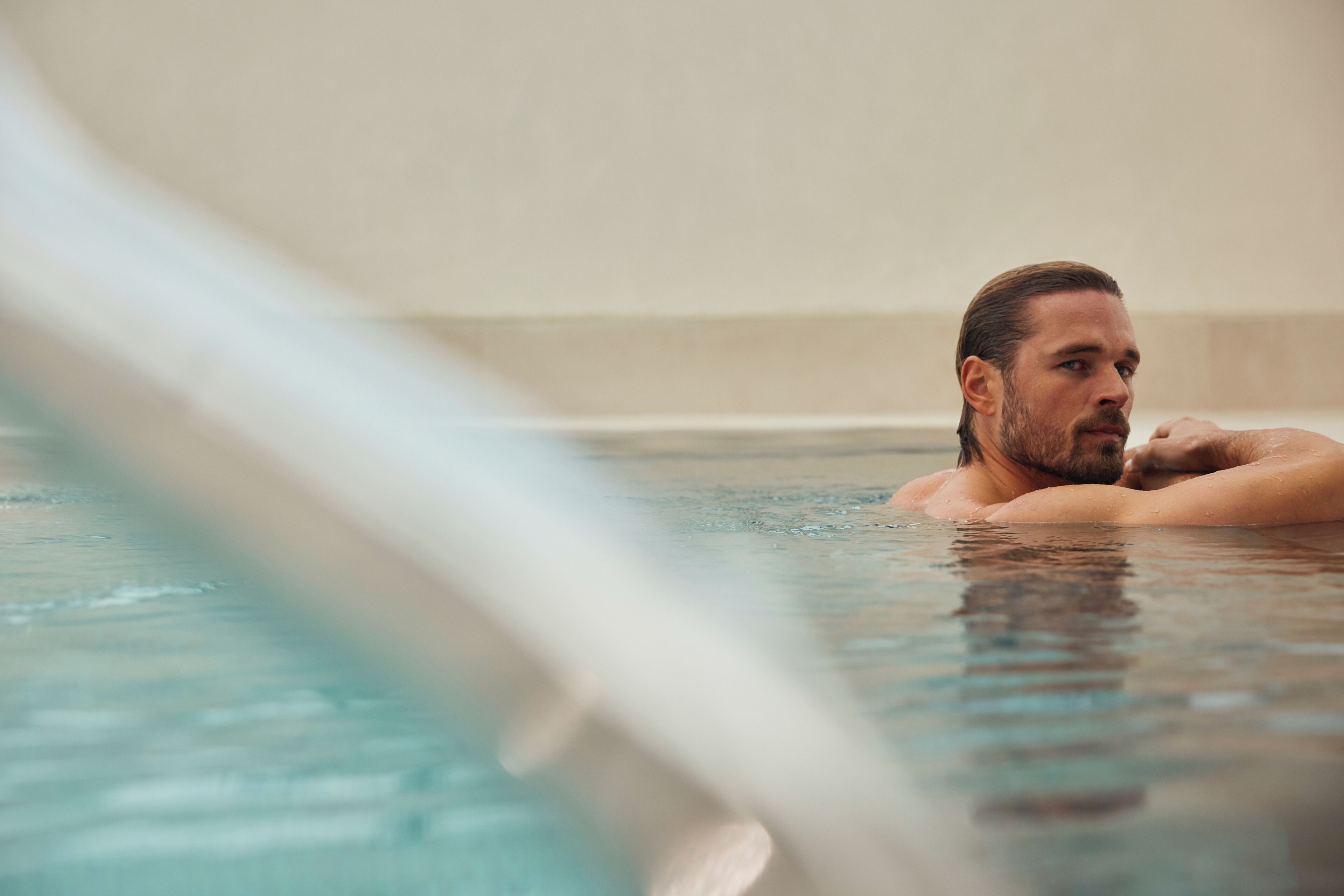 A person in a hot tub with a blurred background.