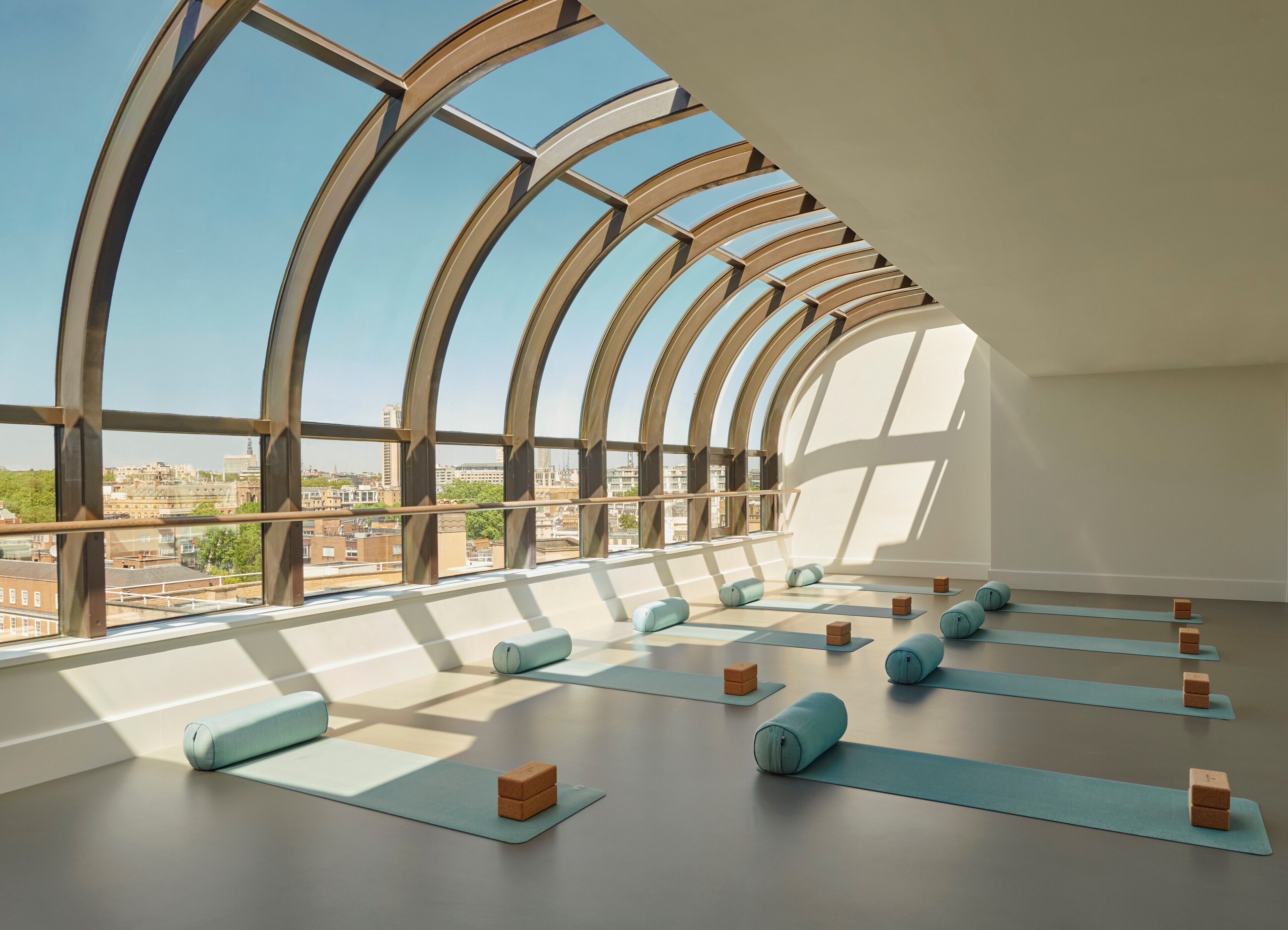 A spacious room with large windows and a view of the cityscape.