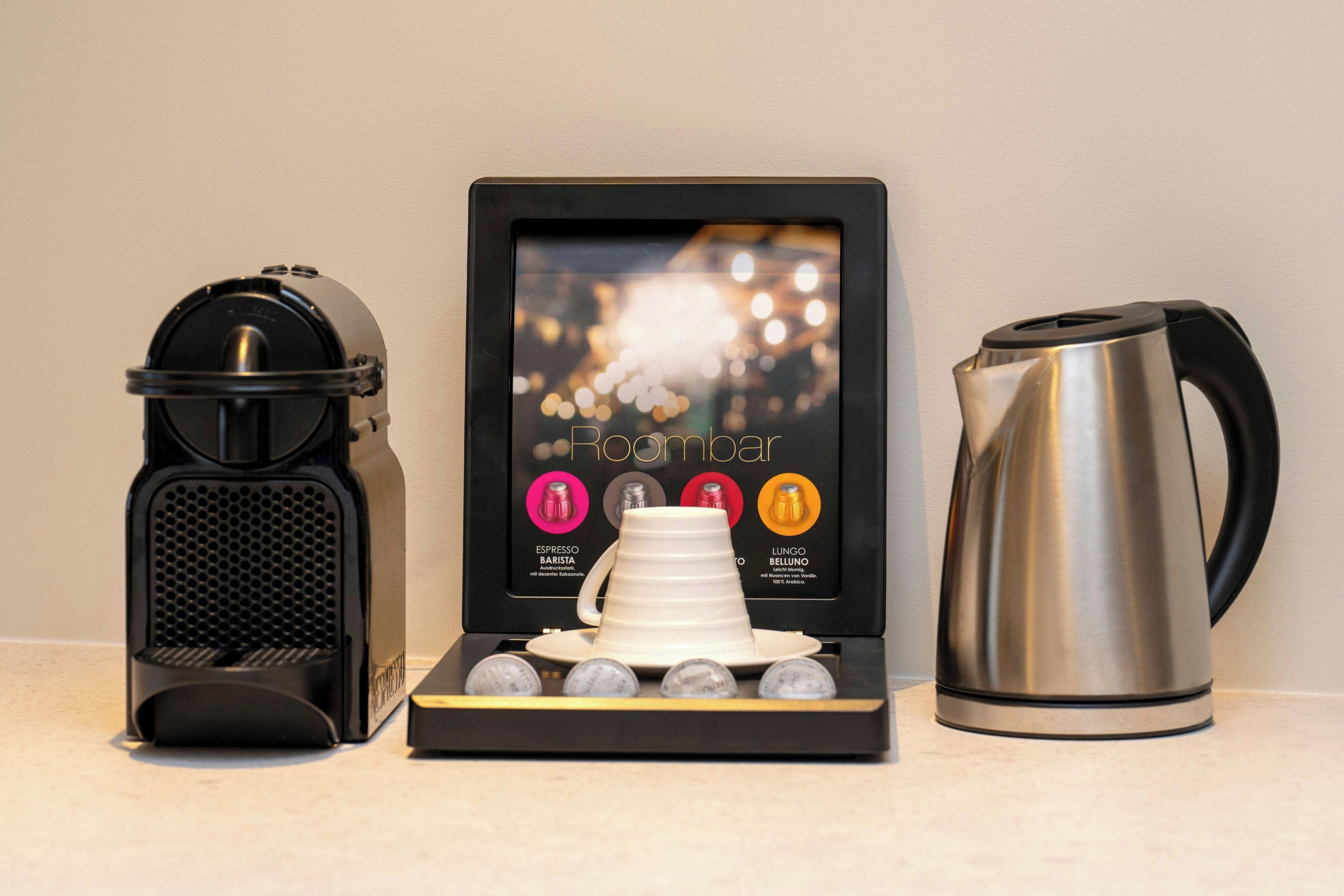 A coffee machine, a coffee pod display, and a coffee pot.