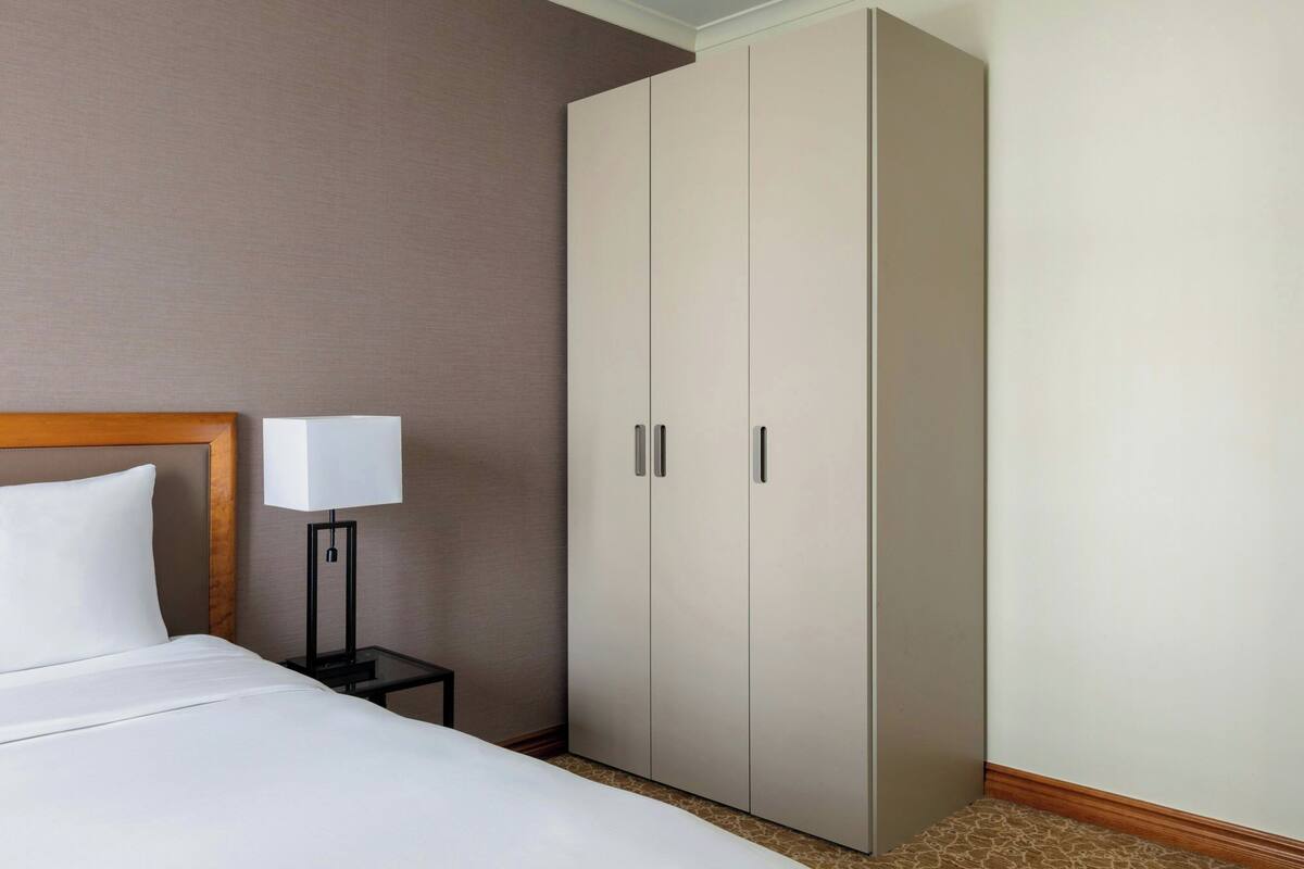 Premium bedding, desk, laptop workspace, blackout drapes