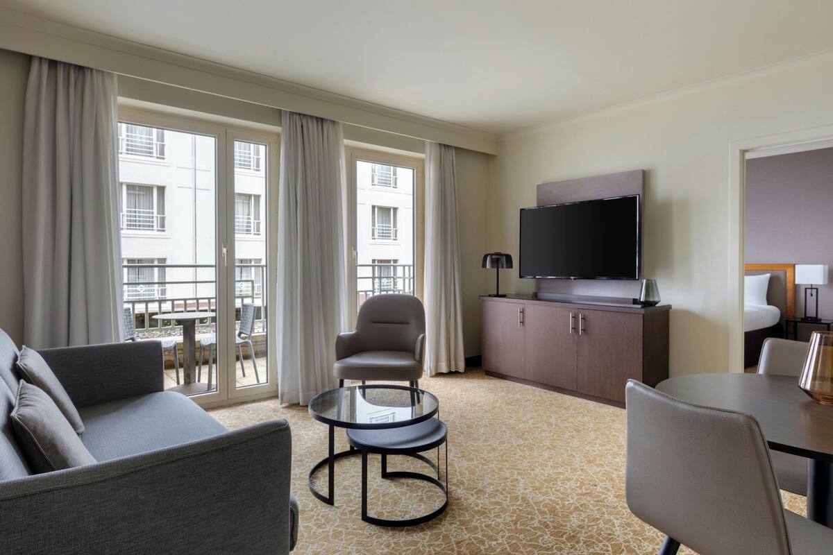 Premium bedding, desk, laptop workspace, blackout drapes