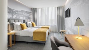 A modern hotel room with two beds, a desk, a chair, and a TV. - Mamaison Residence Downtown (Prague)