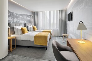 A modern hotel room with two beds, a desk, a chair, and a TV. - Mamaison Residence Downtown (Prague)