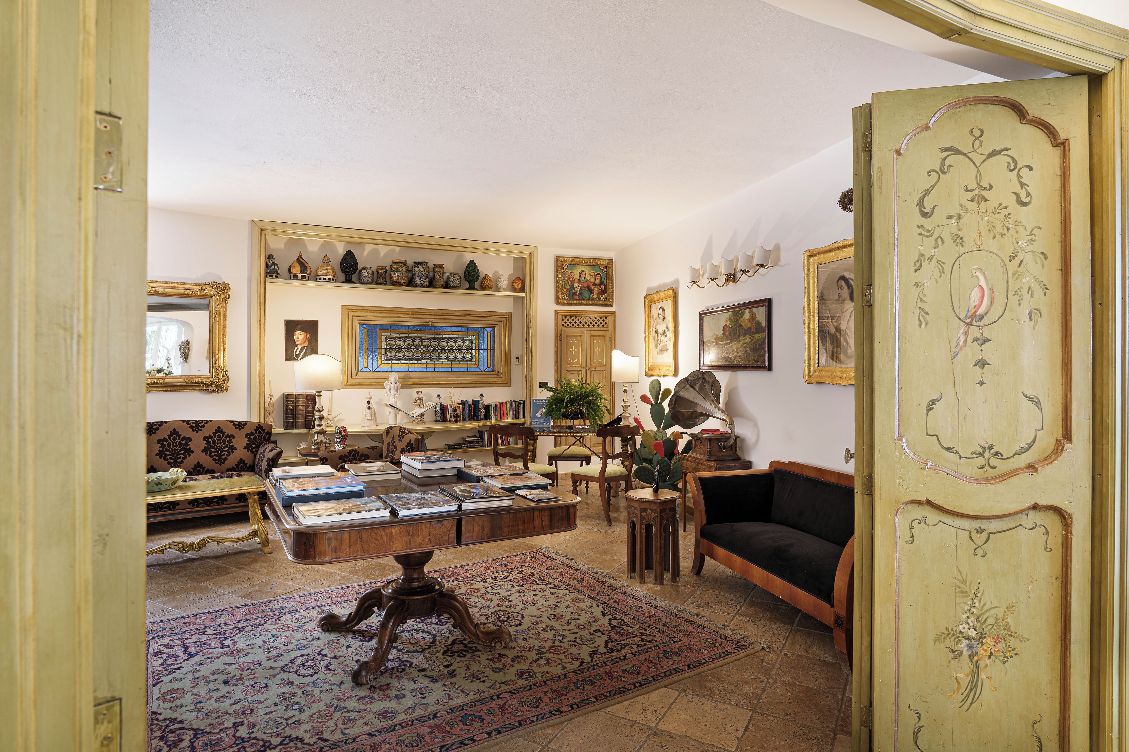 A traditional living room with a sofa, coffee table, and decorative items.