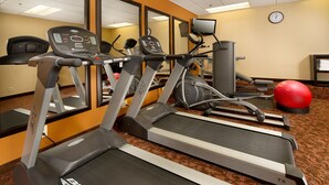 A fitness center with treadmills, a stationary bike, and a red exercise ball. - American Inn Of Bethesda (Bethesda)