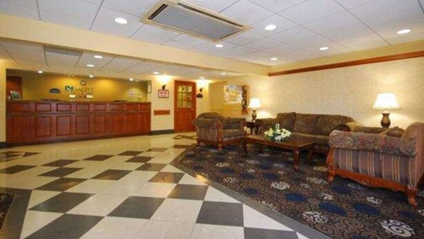 A lobby with a checkered floor, two sofas, a coffee table, and a reception desk. - Quality Inn & Suites Bensalem (Bensalem)