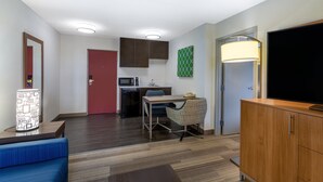 A compact hotel room with a kitchenette, a dining area, a TV, and a large mirror. - Holiday Inn Express Hotel & Suites Philadelphia – King of Prussia by IHG (King of Prussia)