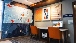 A modern office space with a large wall map, two orange chairs, a desk, and a computer. - Holiday Inn Express Frazer - Malvern by IHG (Malvern)