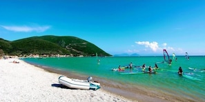 On the beach, black sand, beach umbrellas, beach bar
