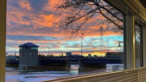 A view of a bridge with a tower, a river, and a sunset sky. - Harbor Winds Hotel (Sheboygan)