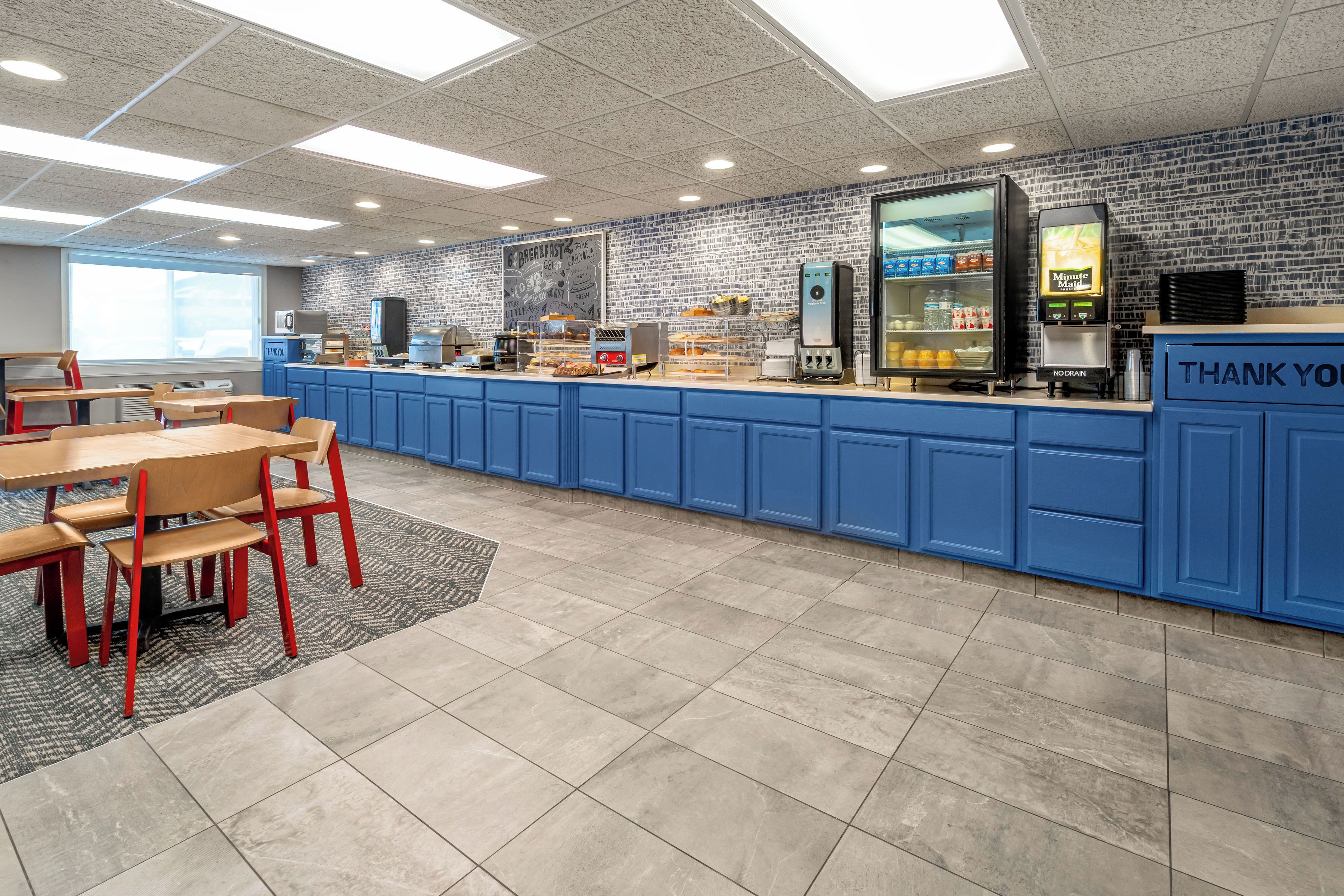 A breakfast area with blue cabinets, a coffee machine, and a 'Thank You' sign.