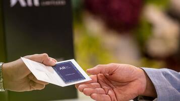 A person handing over a card to another person.