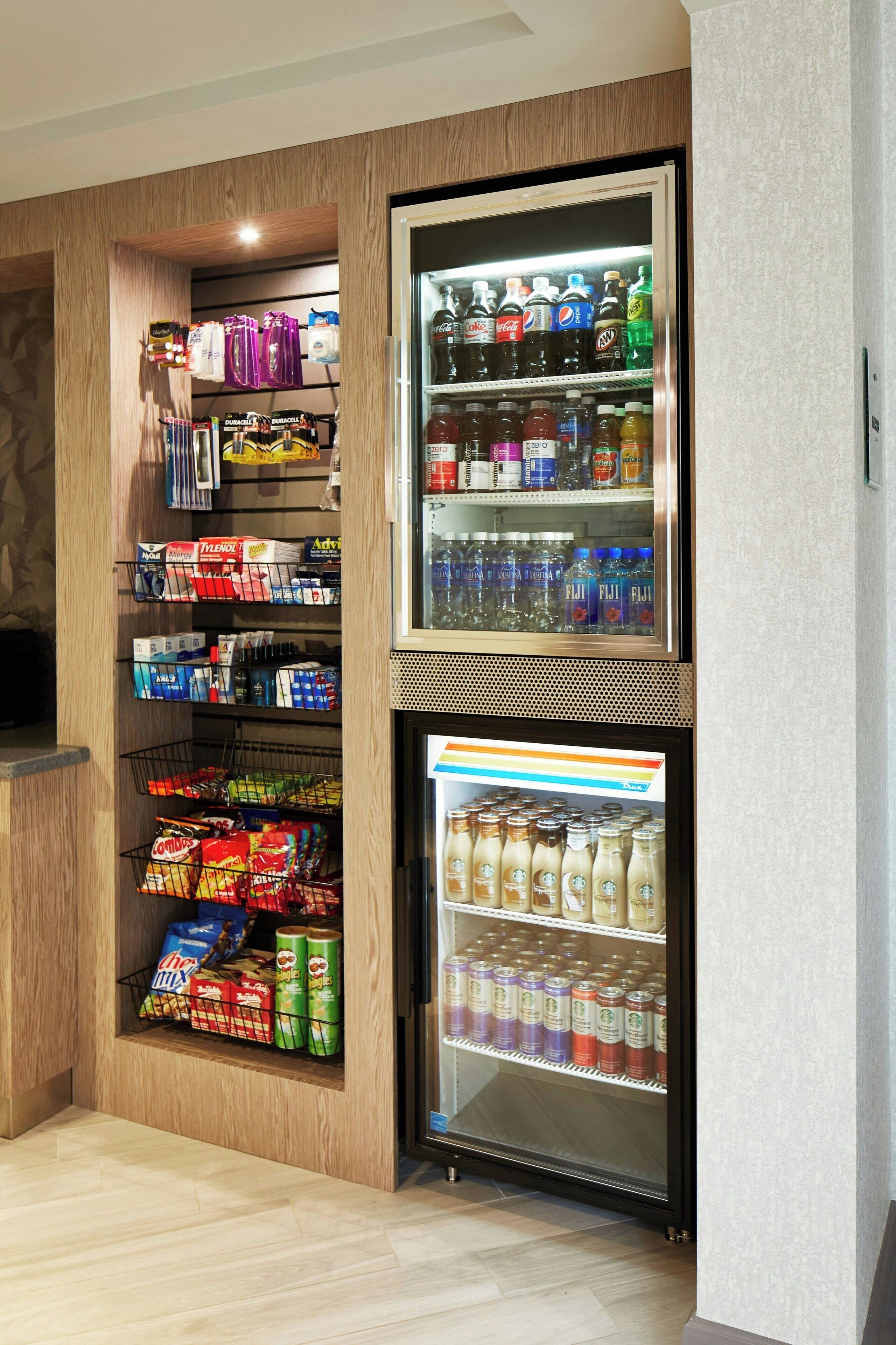 A vending machine stocked with beverages and snacks, including bottled drinks and packaged foods.
