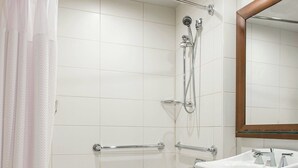 A bathroom with a bathtub, shower, and sink.