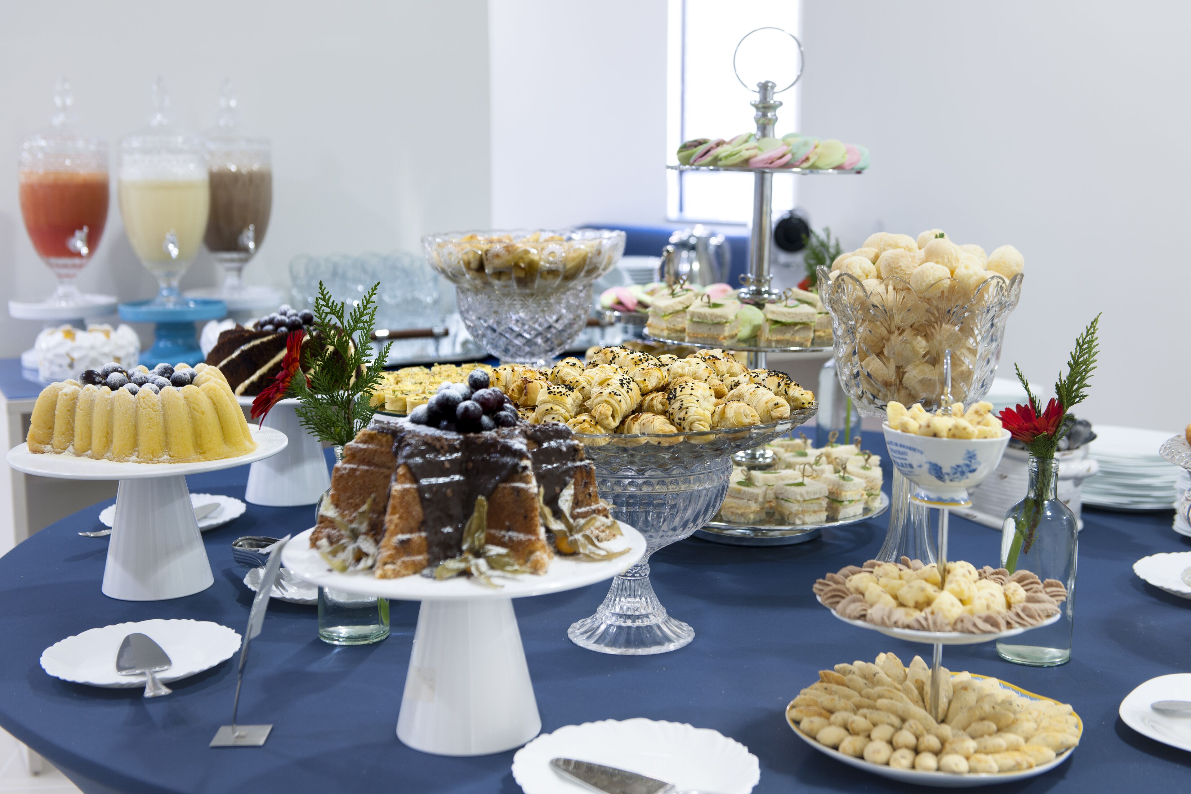 A buffet table with various desserts and beverages.