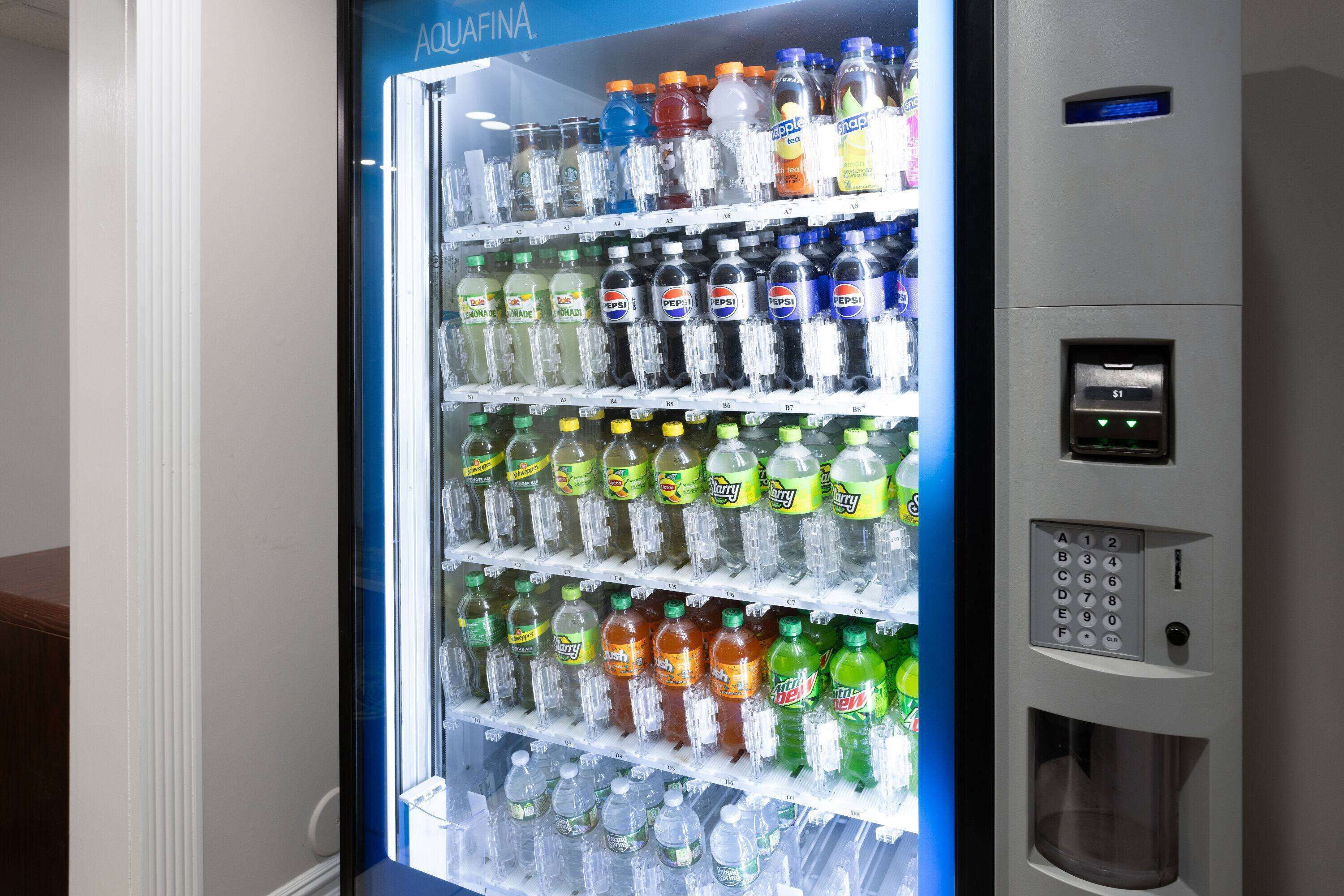 A vending machine stocked with various beverages including sodas and juices.