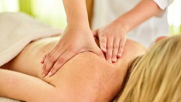 A person receiving a back massage.