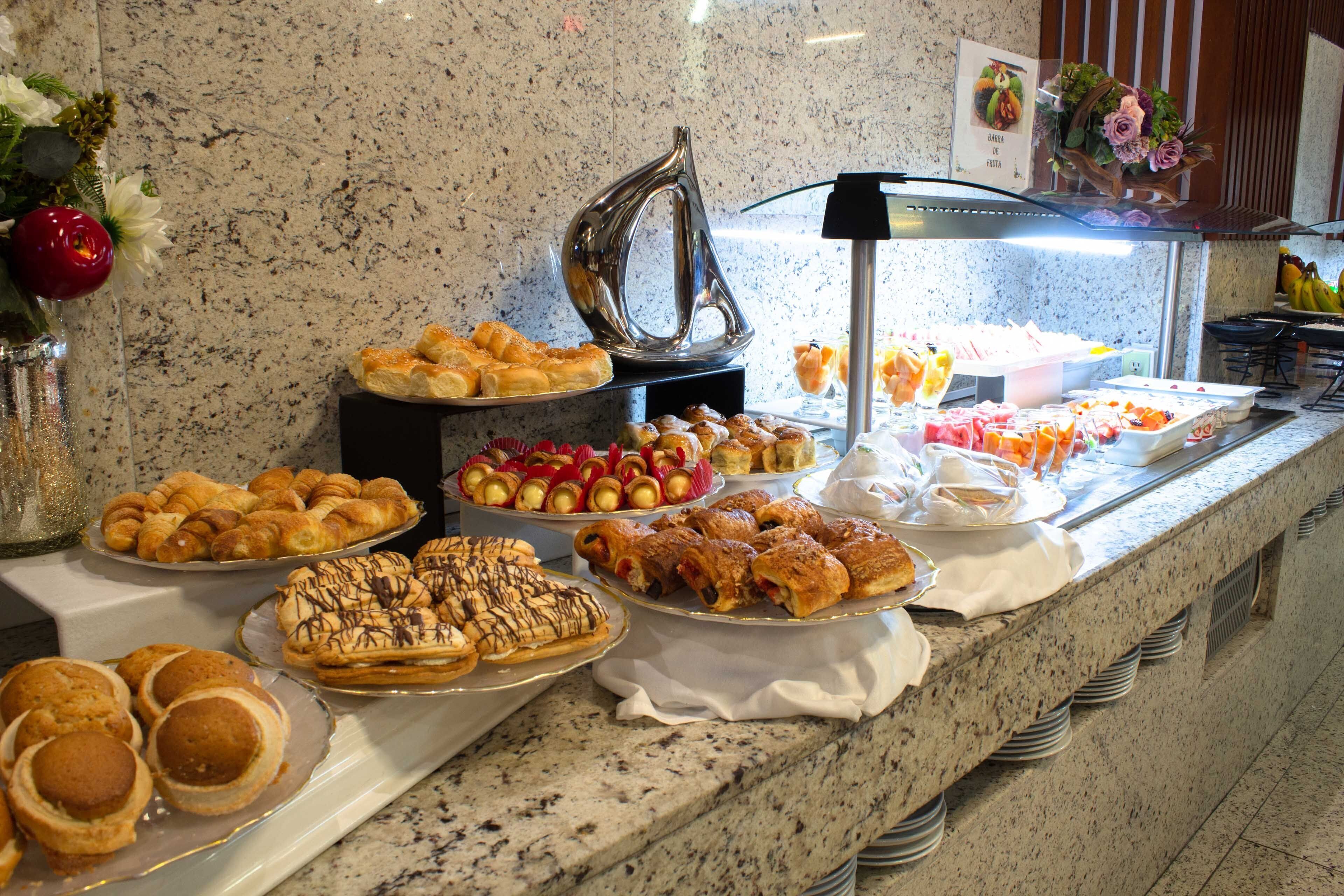 A buffet with various pastries and desserts.