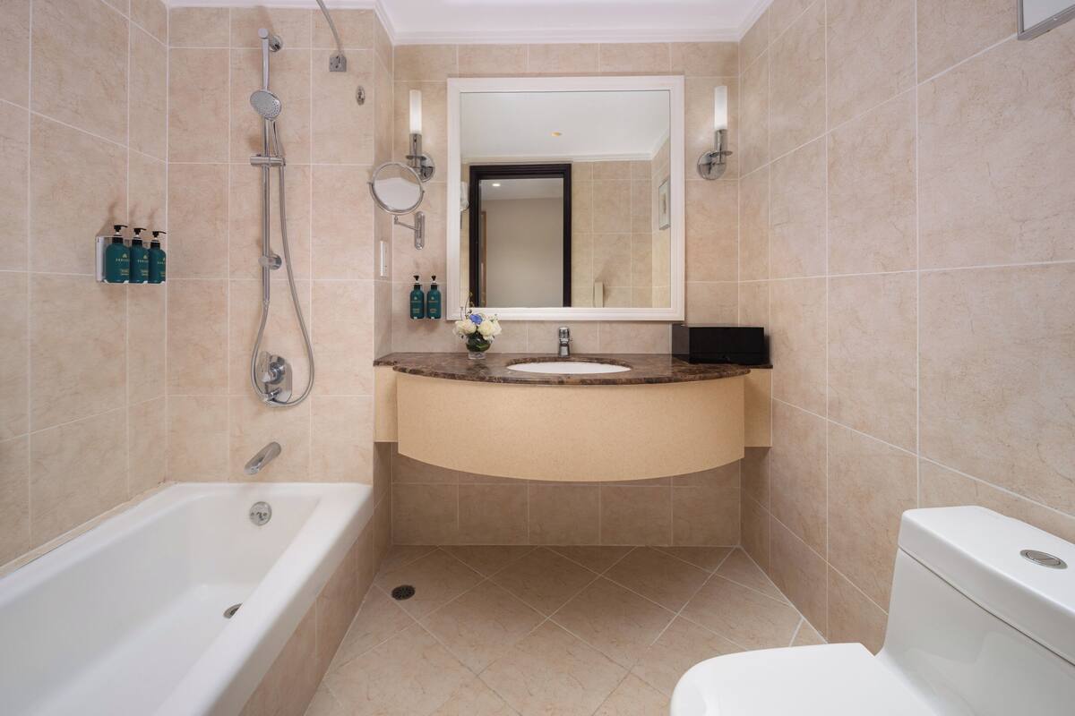 A modern bathroom with a bathtub, a sink, and a toilet.