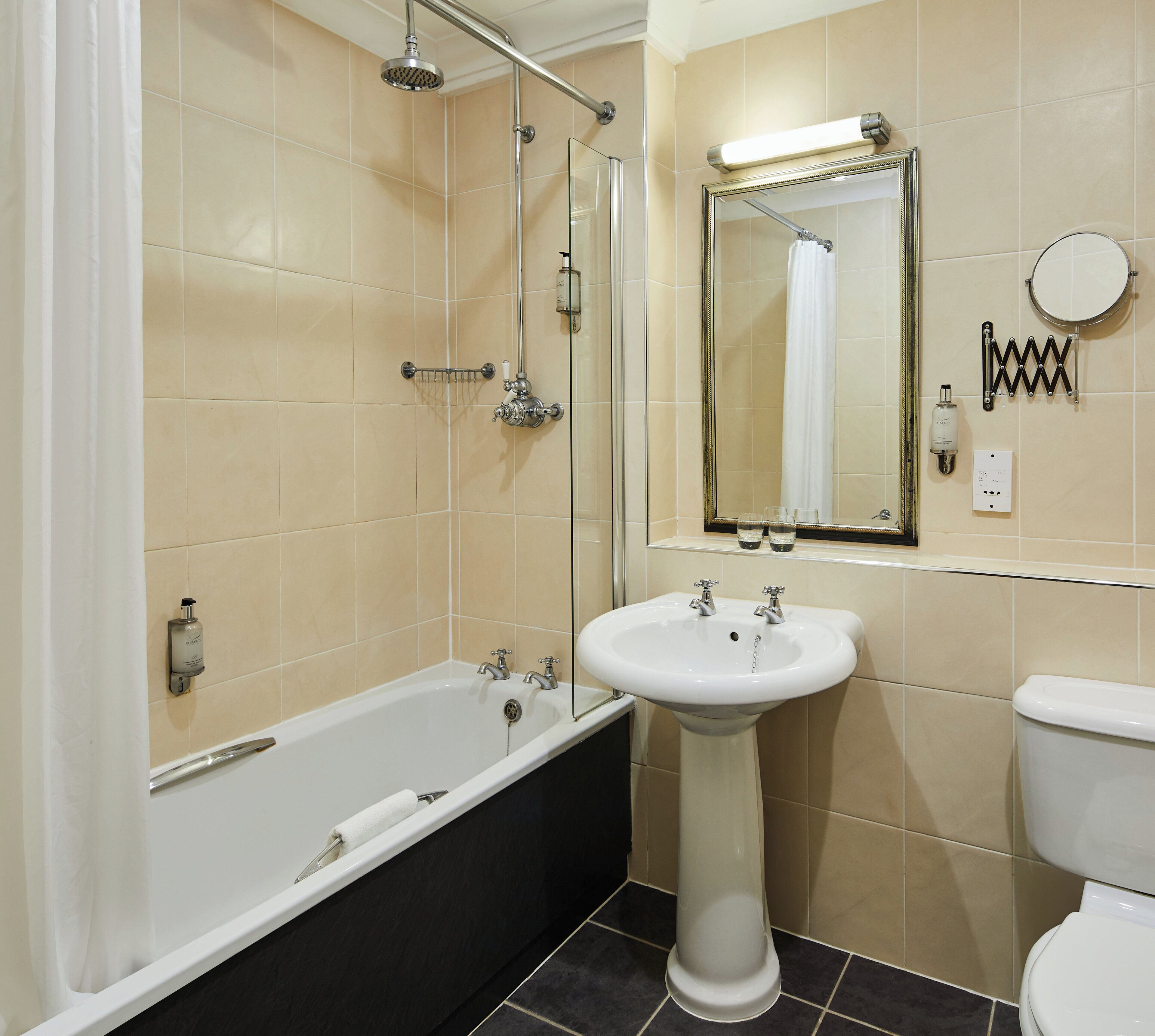 A bathroom with a bathtub, a sink, a toilet, and a shower.