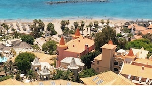 A coastal resort with a beach, pool, and Mediterranean-style architecture. - Bahia del Duque (Adeje)