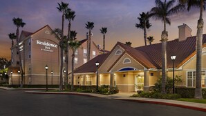 A hotel with a prominent sign, multiple floors, and a well-maintained exterior with palm trees. - Residence Inn Anaheim Hills Yorba Linda (Anaheim)
