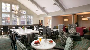 A hotel dining area with tables, chairs, and a breakfast setup. - Residence Inn Anaheim Hills Yorba Linda (Anaheim)
