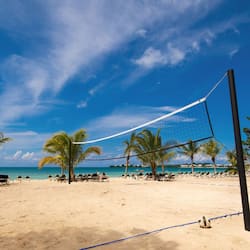 On the beach, white sand, sun loungers, beach towels