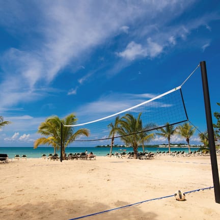 On the beach, white sand, sun loungers, beach towels