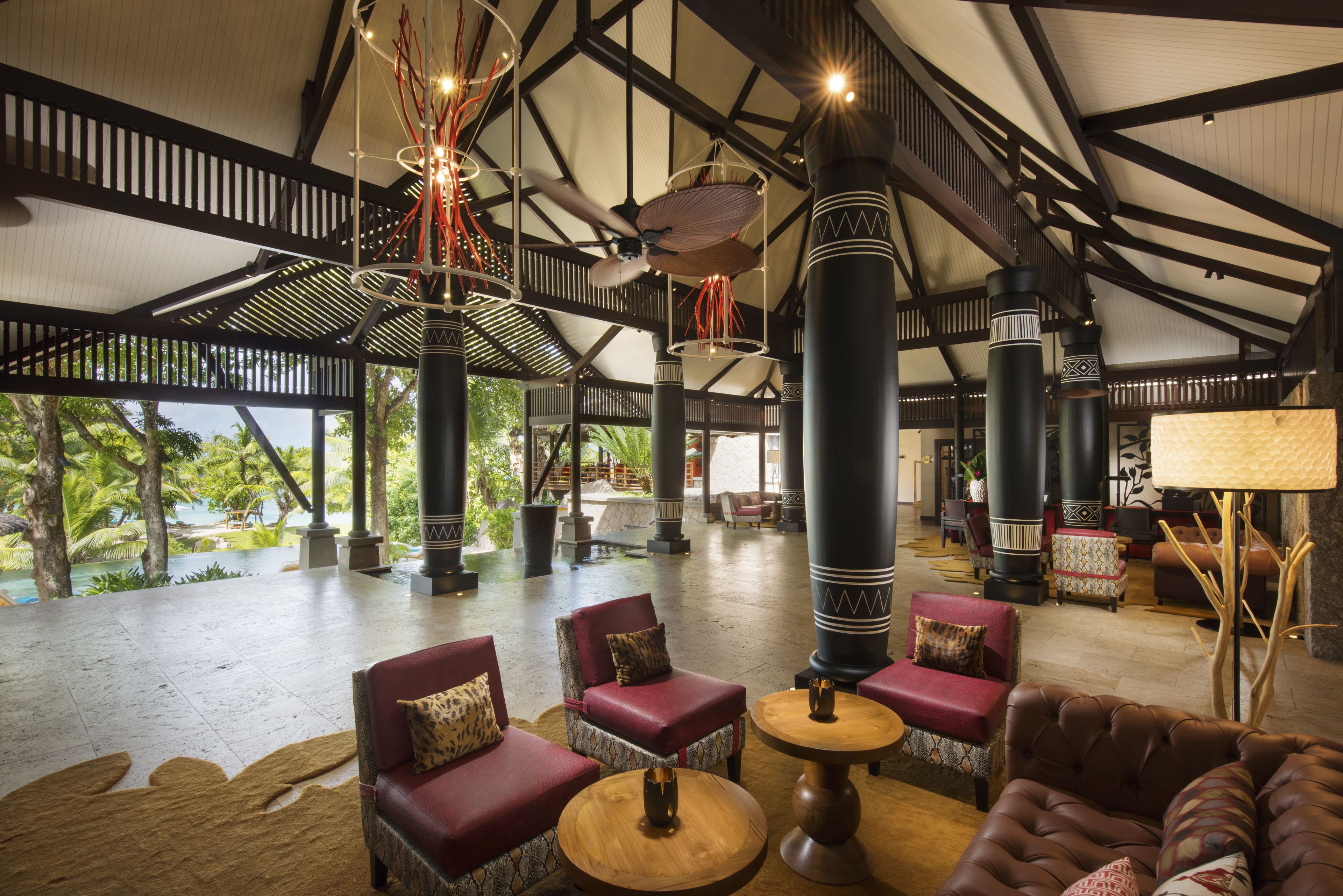 A spacious lobby with high ceilings, large pillars, and seating areas.