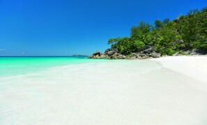 On the beach, white sand, beach towels, windsurfing