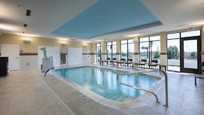 An indoor swimming pool with clear water, surrounded by tiled flooring and a blue ceiling. - Courtyard by Marriott Russellville (Russellville)