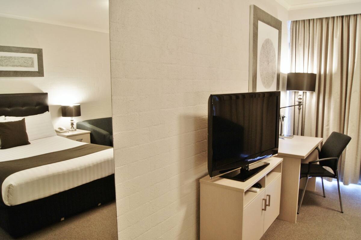 Desk, laptop workspace, blackout curtains, iron/ironing board