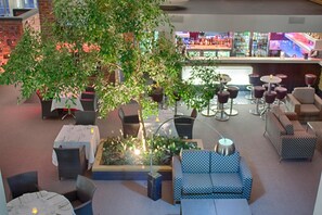 Relax and socialize in our inviting lounge area with comfortable seating and a natural centerpiece.