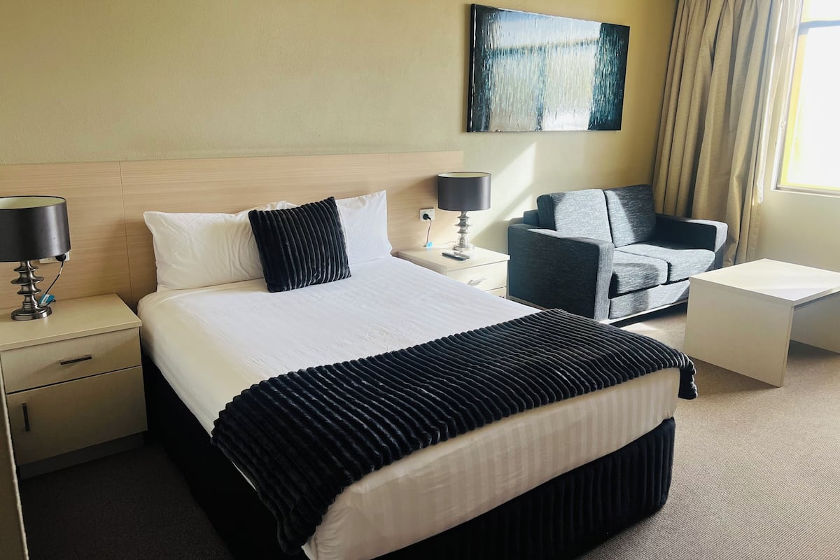 Desk, laptop workspace, blackout drapes, iron/ironing board