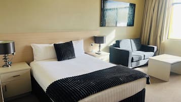 Desk, laptop workspace, blackout curtains, iron/ironing board