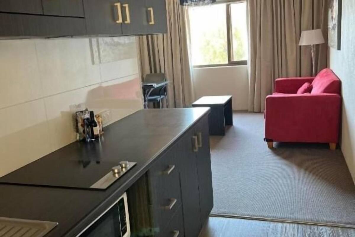 Desk, laptop workspace, blackout curtains, iron/ironing board