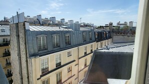 A view of a row of buildings with multiple balconies and a clear sky.