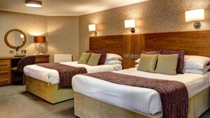 A hotel room with two beds, a desk, a chair, and a mirror. - Golden Lion Hotel (Stirling)