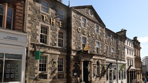 A historic stone building with the sign "THE GOLDEN LION" indicating a restaurant or pub. - Golden Lion Hotel (Stirling)
